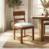 Acacia wood dining chair with live edge wooden backrest and cushioned seat placed beside a wooden dining table