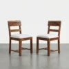Acacia wood dining chair with live edge wooden backrest and cushioned seat placed beside a wooden dining table set of 2